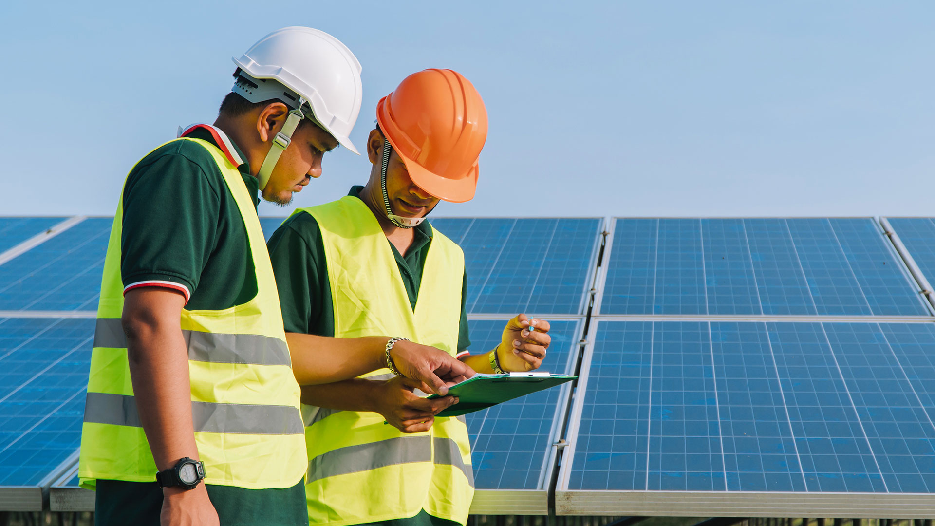 Two workers at a solar farm