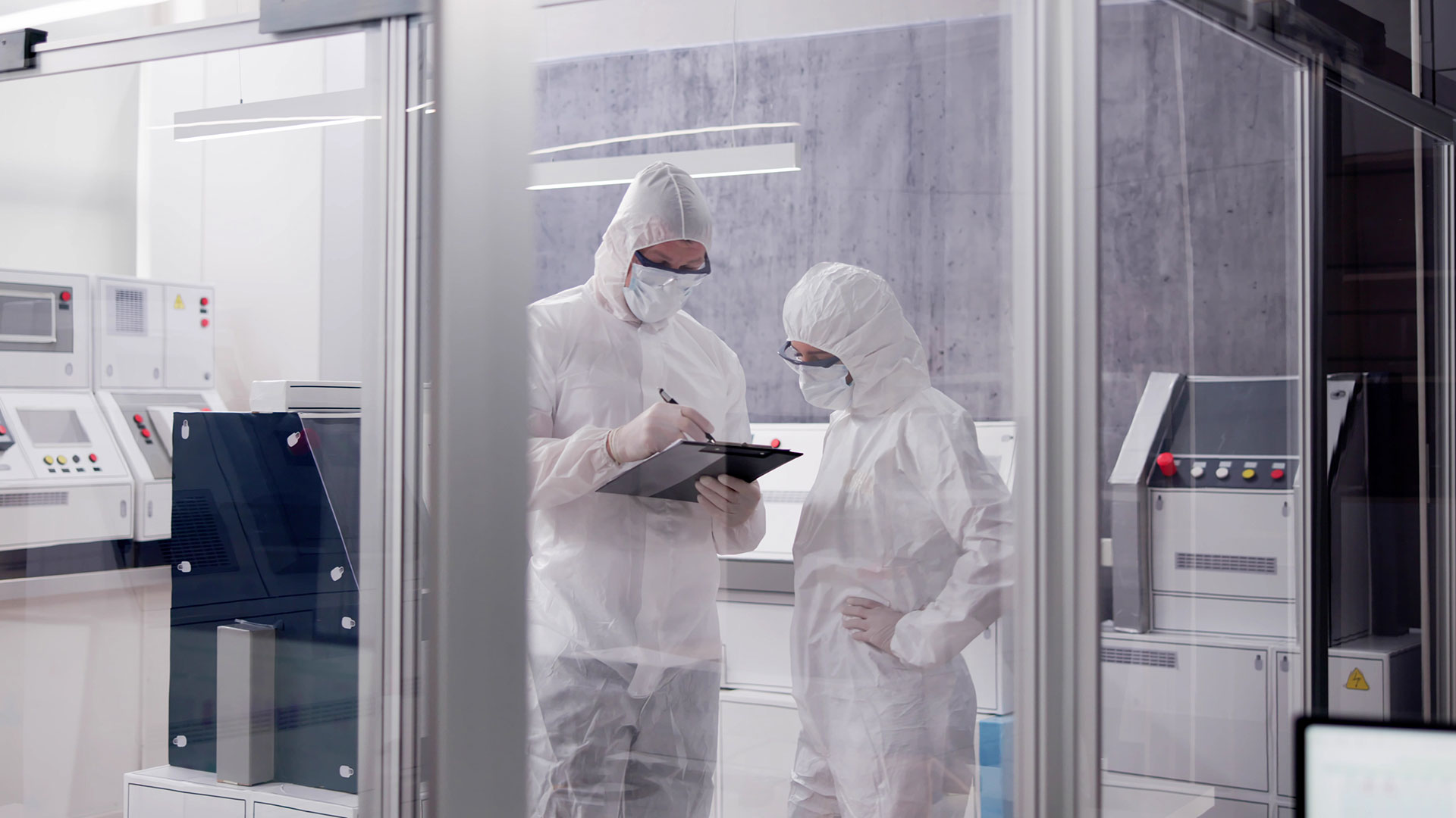 Two lab technicians in a clean room lab