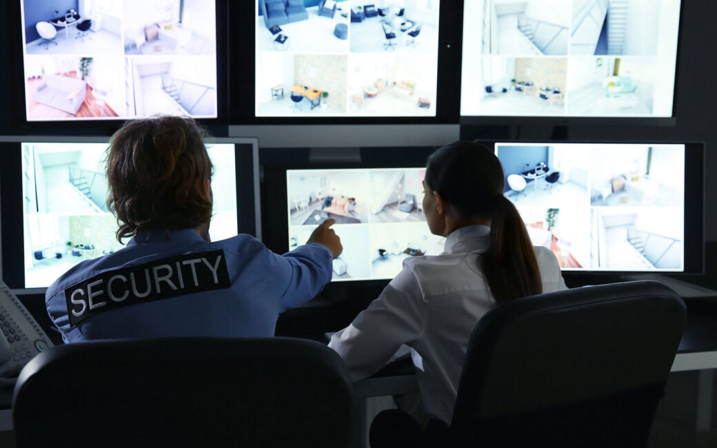 Security team watching surveillance monitors