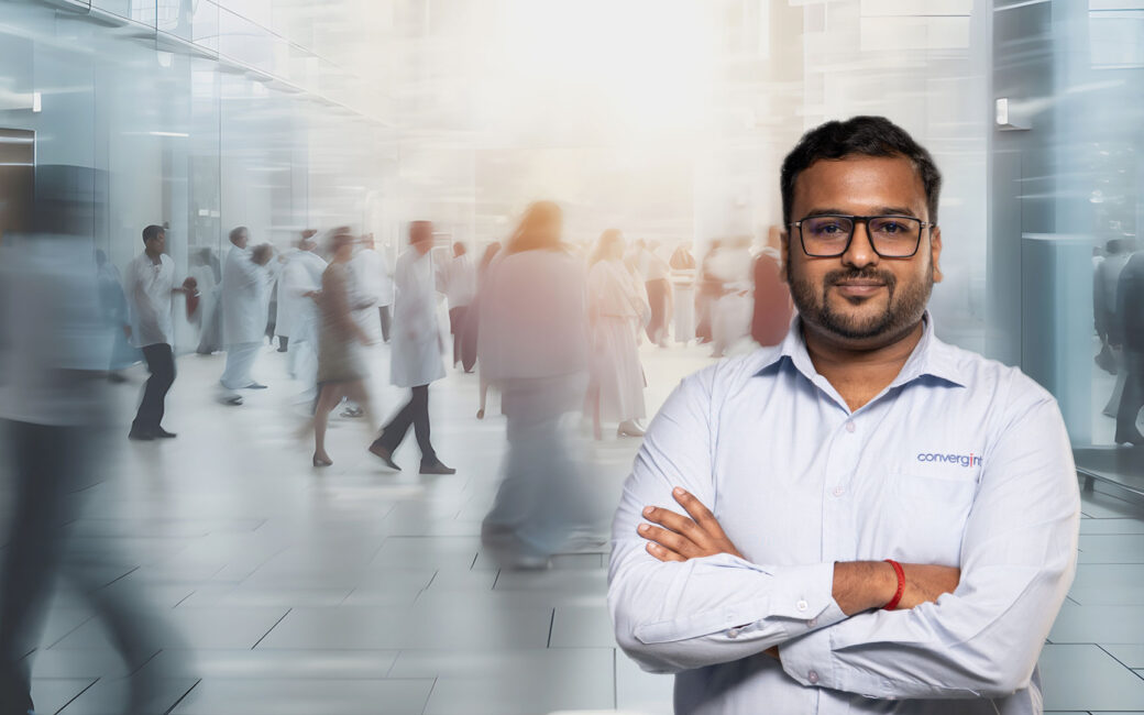 Convergint worker in front of blurred people in a lobby