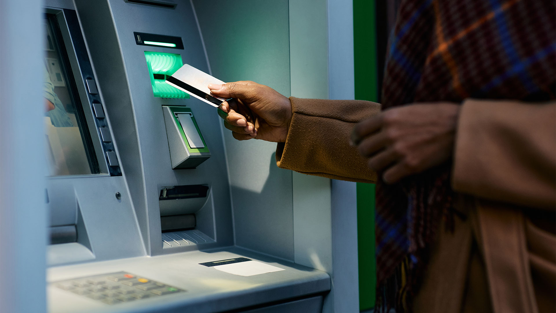 Woman using secure ATM