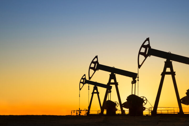 Silhouette of oil wells at sunset