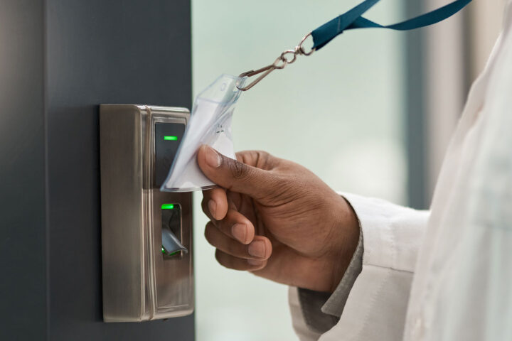 Closeup shot of a physician using an access card to gain entry at a door