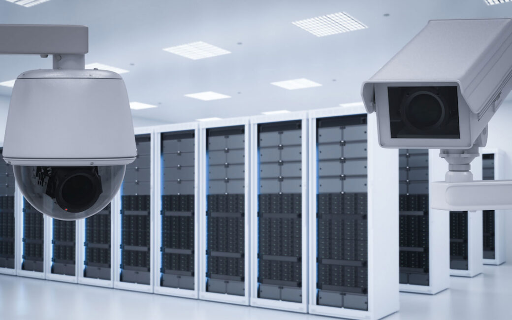 two white security cameras in an all-white server room